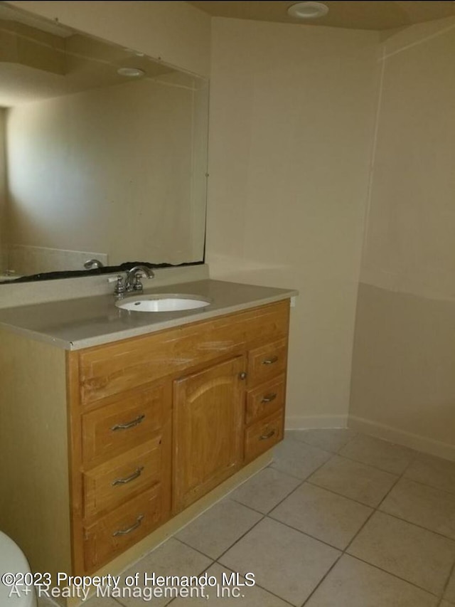 bathroom with tile patterned flooring and vanity