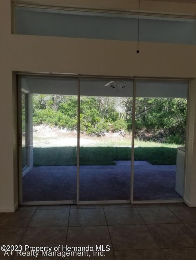 doorway with tile patterned flooring