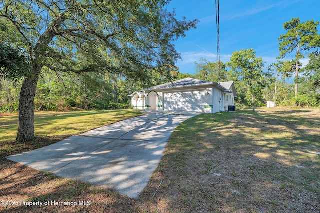 view of side of home featuring a garage, central AC, and a lawn