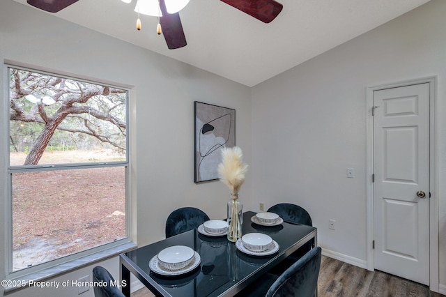 dining space with hardwood / wood-style floors, vaulted ceiling, and ceiling fan