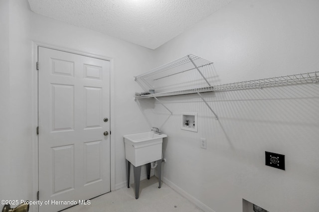 clothes washing area featuring electric dryer hookup, washer hookup, and a textured ceiling