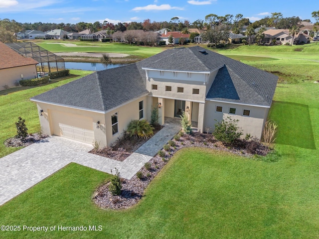 view of front of house featuring a garage, a front lawn, and glass enclosure