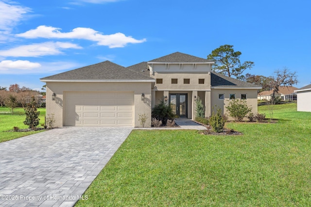 view of front of home with a garage and a front lawn