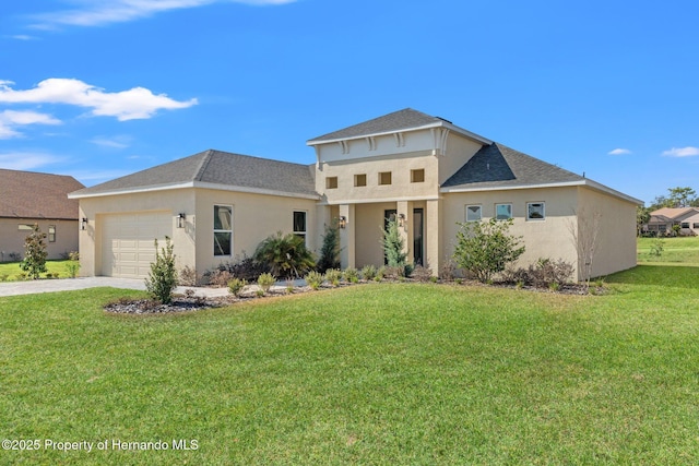 view of front of home with a garage and a front lawn