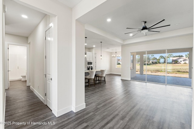 hall featuring dark hardwood / wood-style floors and a chandelier