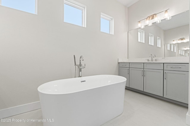 bathroom with a washtub and vanity