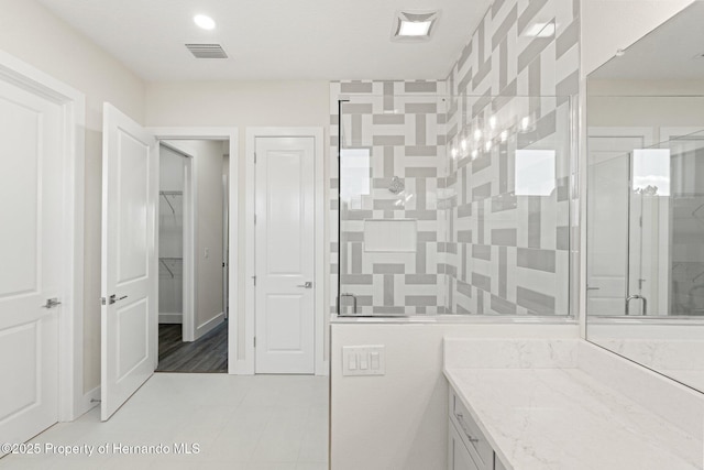 bathroom featuring vanity and an enclosed shower