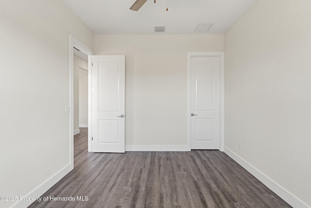 unfurnished bedroom with ceiling fan and dark hardwood / wood-style flooring