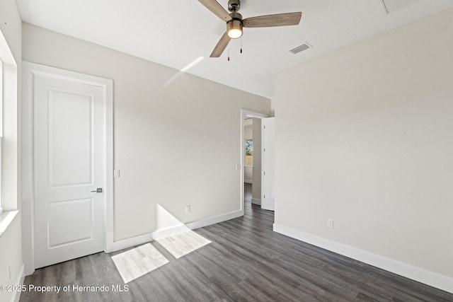 unfurnished bedroom with dark hardwood / wood-style flooring and ceiling fan