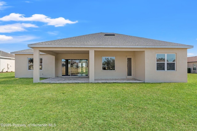 rear view of property with a yard and a patio