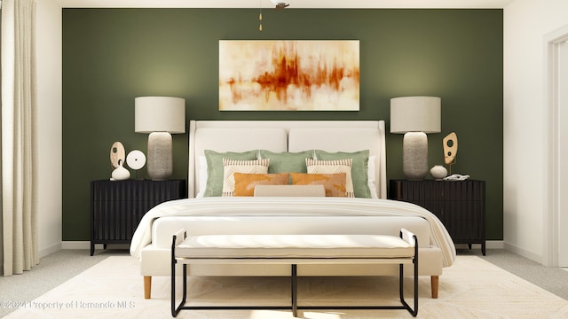 bedroom with radiator heating unit and light carpet