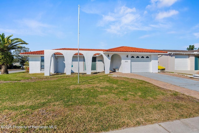 view of front of property with a garage and a front lawn