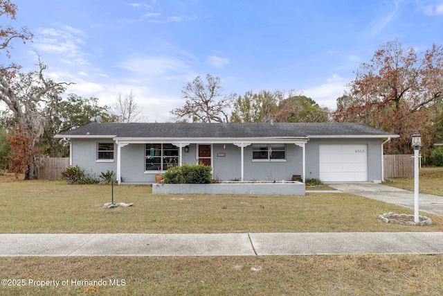 ranch-style house featuring a garage and a front yard