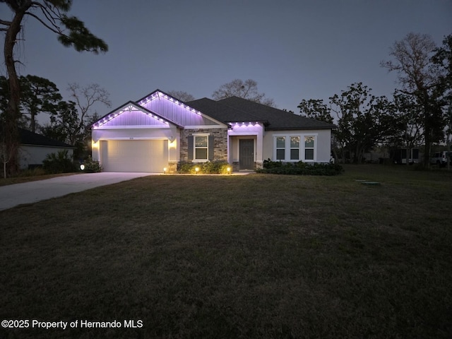 view of front of house with a garage and a front lawn