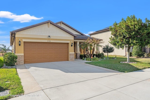 craftsman-style home featuring a garage and a front lawn