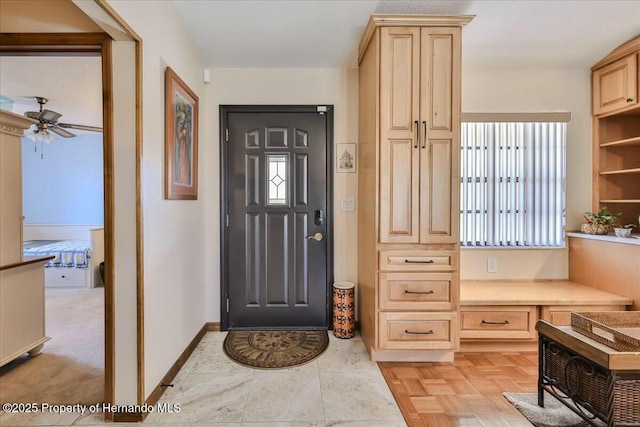 entrance foyer with ceiling fan