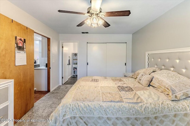 carpeted bedroom with ceiling fan and a closet