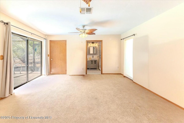 empty room with ceiling fan and light colored carpet