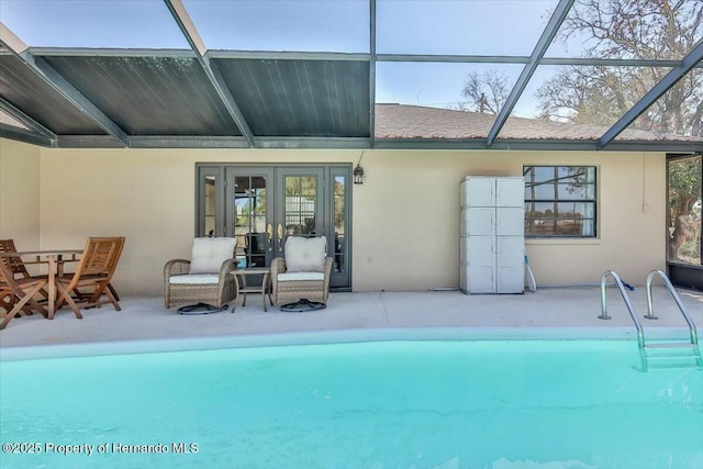 view of pool featuring glass enclosure