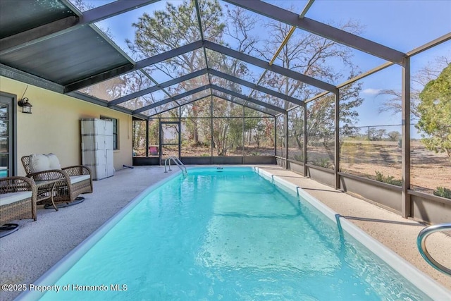 view of pool featuring a patio and glass enclosure