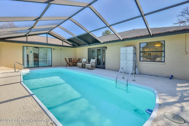 view of swimming pool featuring a lanai and a patio area