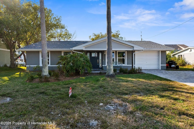 ranch-style house featuring a garage and a front yard