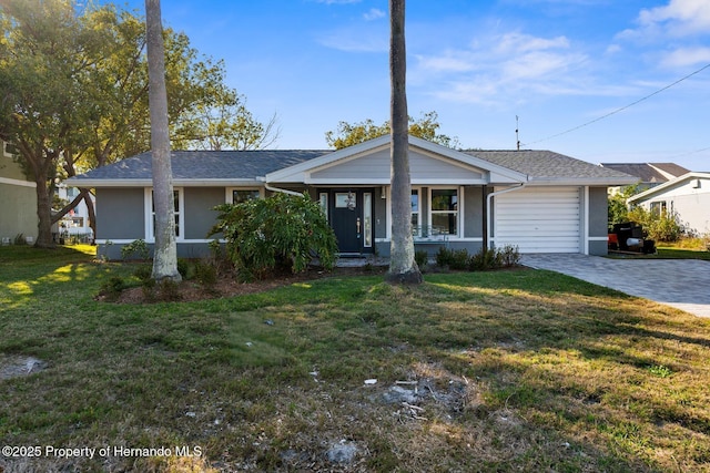 view of front of property featuring decorative driveway, an attached garage, stucco siding, and a front yard