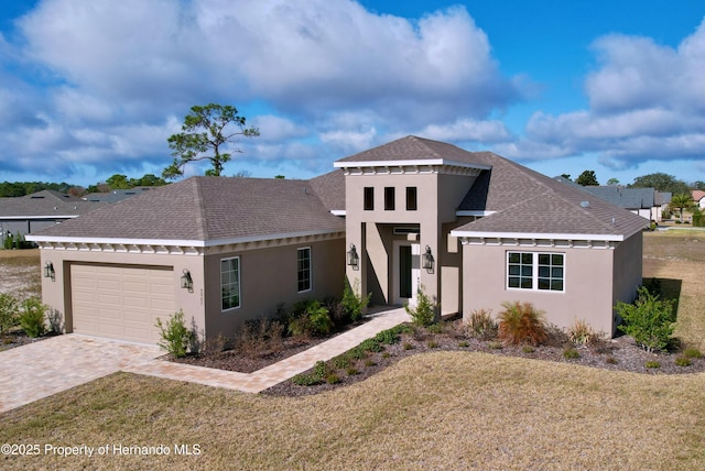 view of front of home with a garage and a front yard