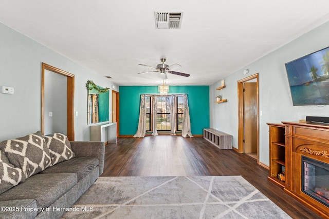 living room featuring ceiling fan and dark hardwood / wood-style flooring