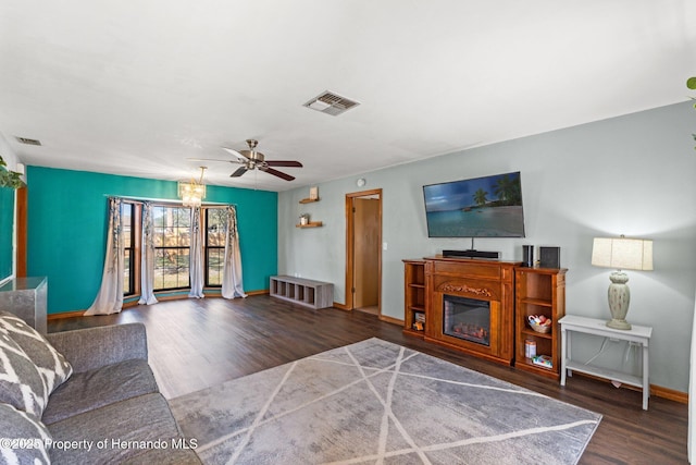 living room featuring dark hardwood / wood-style flooring and ceiling fan