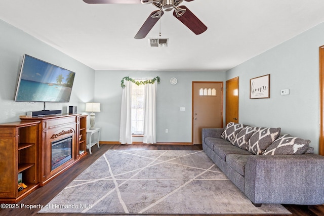 living room with wood-type flooring and ceiling fan