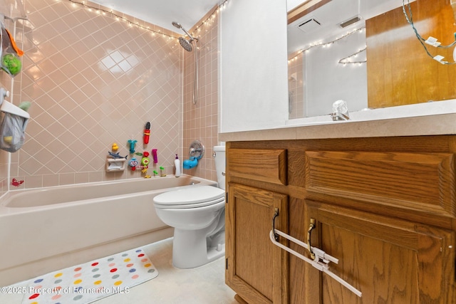 full bathroom with vanity, tiled shower / bath combo, and toilet