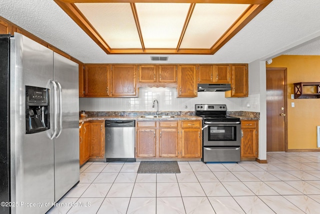 kitchen featuring sink, light stone counters, tasteful backsplash, ventilation hood, and stainless steel appliances