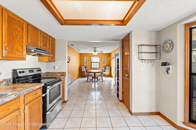 kitchen with decorative backsplash, light tile patterned flooring, a textured ceiling, and stainless steel electric range oven