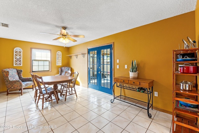 dining space featuring light tile patterned floors, a textured ceiling, ceiling fan, and french doors