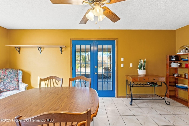 dining room featuring light tile patterned floors, french doors, a textured ceiling, and ceiling fan