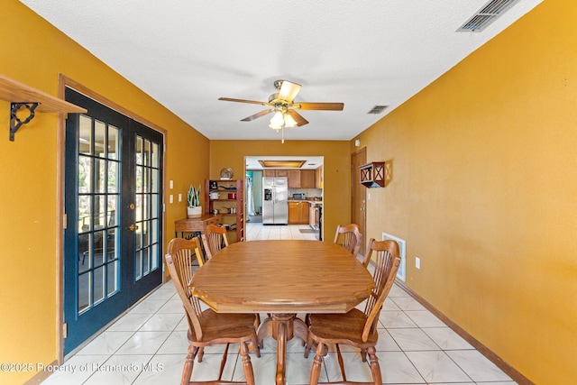 tiled dining area featuring french doors and ceiling fan