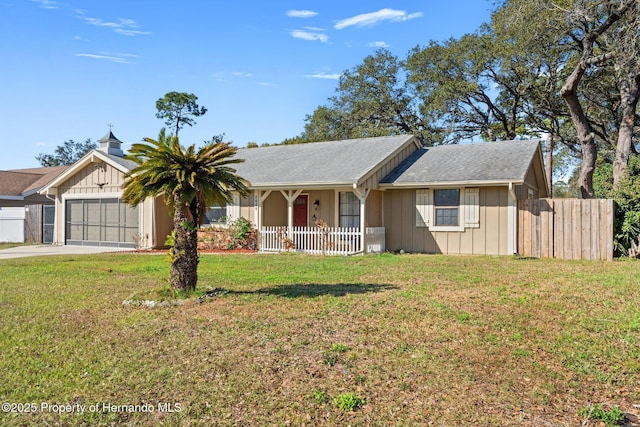 ranch-style house with a garage and a front lawn