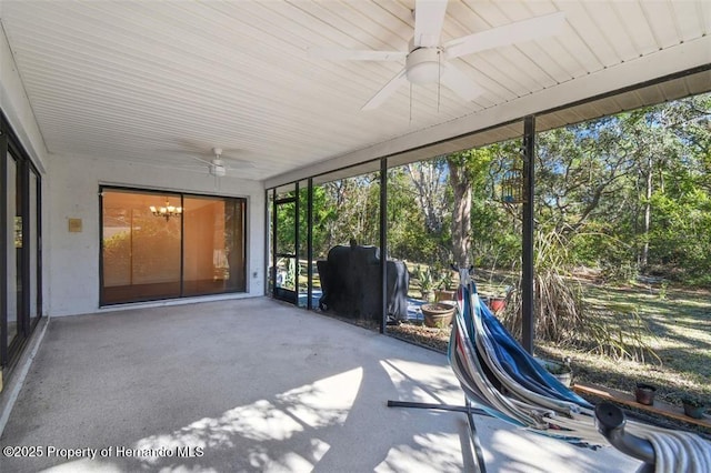 unfurnished sunroom with ceiling fan