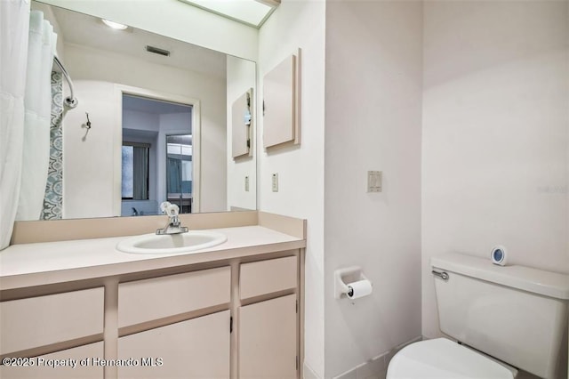 bathroom featuring vanity and toilet