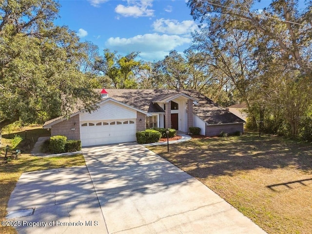 view of front of property featuring a garage and a front lawn