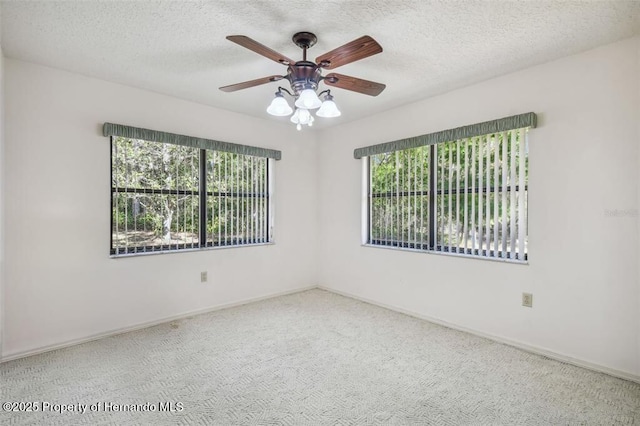 unfurnished room featuring ceiling fan, carpet floors, and a textured ceiling