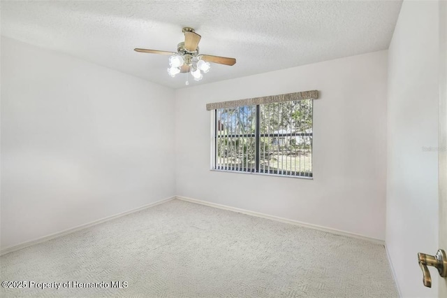 spare room with ceiling fan, carpet floors, and a textured ceiling