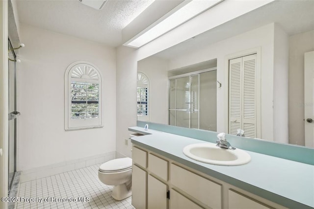 bathroom with vanity, an enclosed shower, tile patterned floors, and toilet