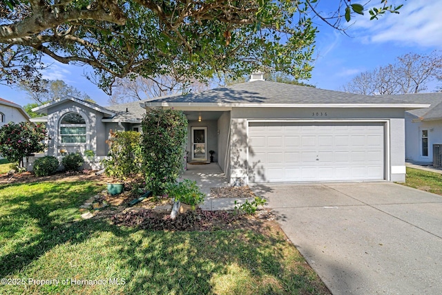 single story home featuring a garage and a front lawn