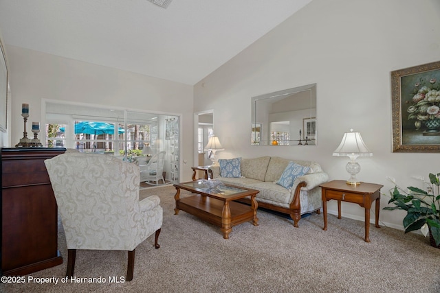 carpeted living room featuring high vaulted ceiling