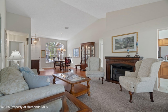 living room with an inviting chandelier and lofted ceiling