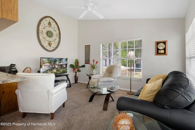 living room featuring ceiling fan, lofted ceiling, and carpet