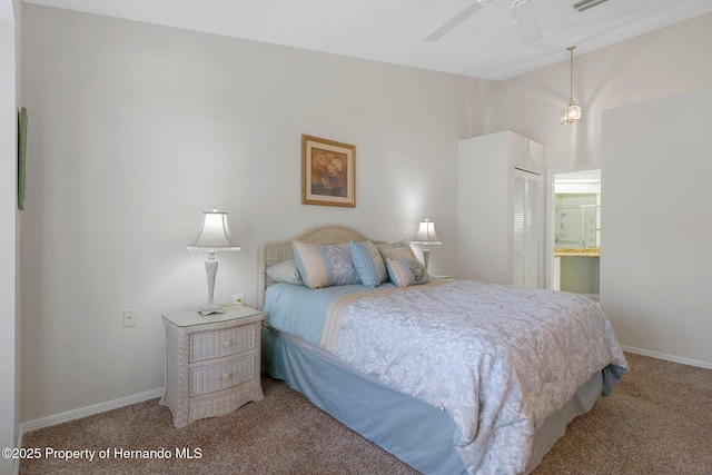 carpeted bedroom featuring ceiling fan, ensuite bath, vaulted ceiling, and a closet