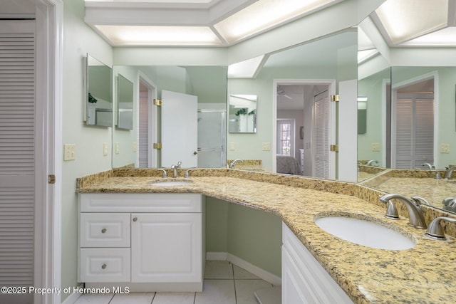 bathroom featuring tile patterned floors, vanity, and a shower with shower door